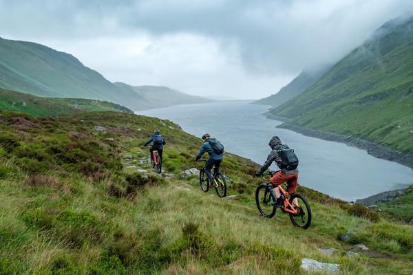 three riders above a reservoirs in y eryri